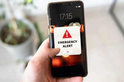 Smartphone showing emergency alert notification for LMC Alert system in Lalitpur