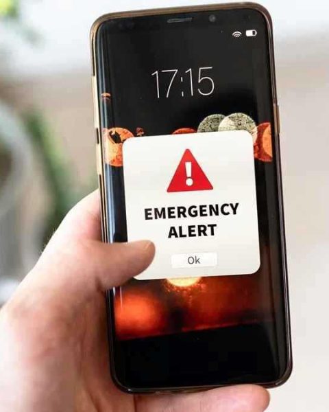 Smartphone showing emergency alert notification for LMC Alert system in Lalitpur